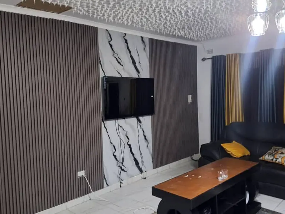 Completed fluted panel feature wall with TV in a living room